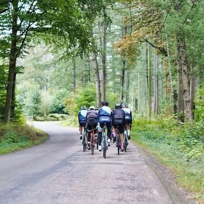 Group of people cycling together on a scenic path.