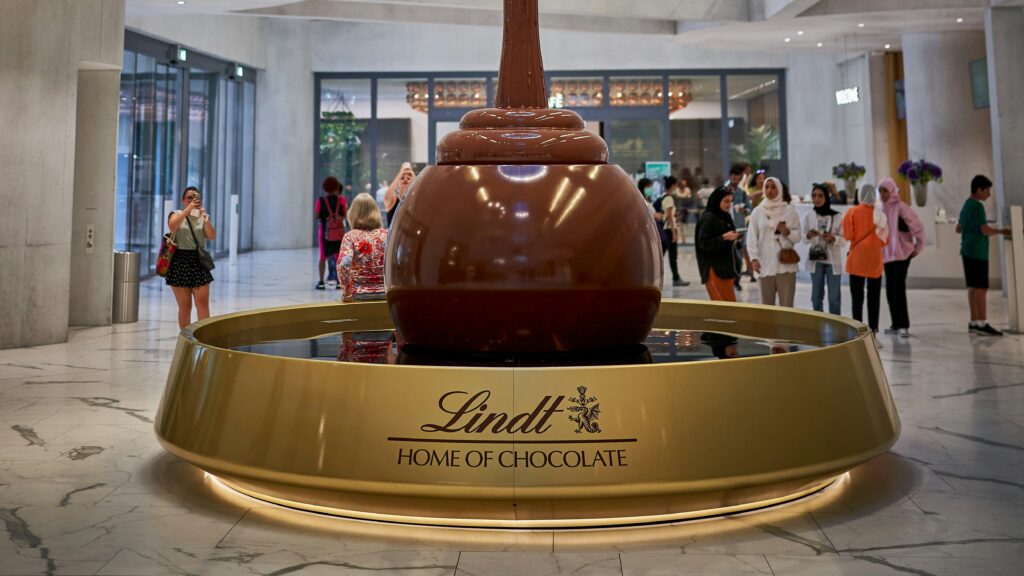 Lindt chocolate fountain with smooth, flowing chocolate ready for dipping.