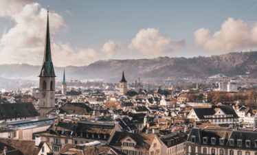 View of Zurich's Old Town with narrow cobblestone streets, historic buildings, and medieval architecture.