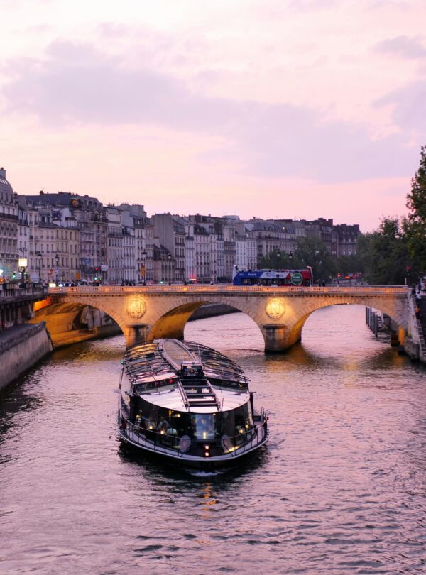 Riverboat cruise navigating along a calm river, offering scenic views of the surrounding landscape.