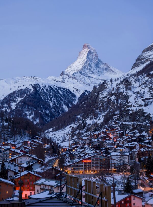 Almost nightfall in Zermatt with the Matterhorn mountain silhouetted against the darkening sky.