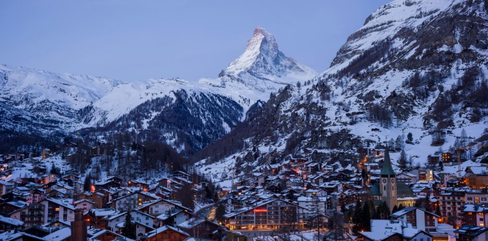 Almost nightfall in Zermatt with the Matterhorn mountain silhouetted against the darkening sky.